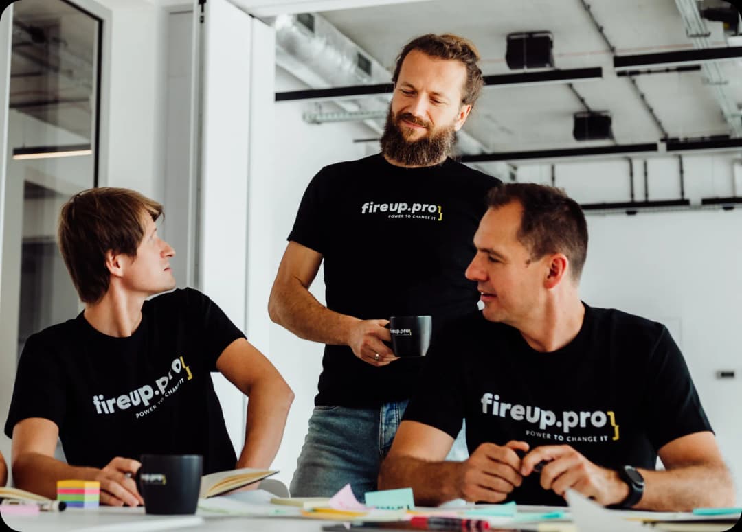 Three senior developers combine the pleasure of sipping aromatic coffee in the modern space of our office with a conversation about digital process optimization—a topic of great importance to both our company and our clients.